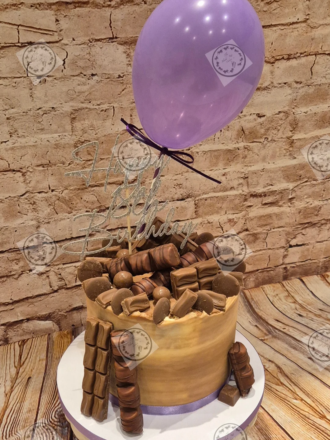 Close-up of a bouquet of deep black roses used as cake styling props, echoing The Black Rat Cakery's dark, characterful branding