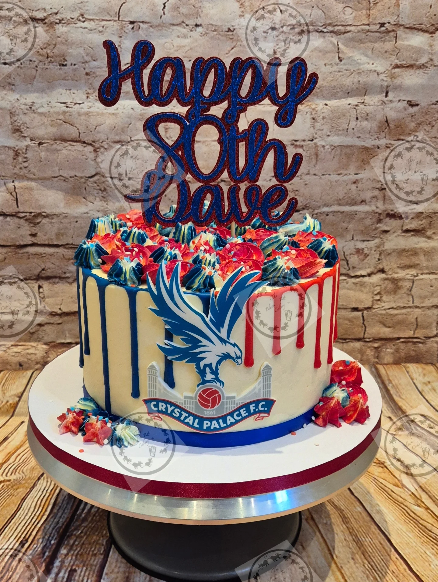 Ivory and blue drip cake decorated with a Crystal Palace FC crest for an 80th birthday celebration